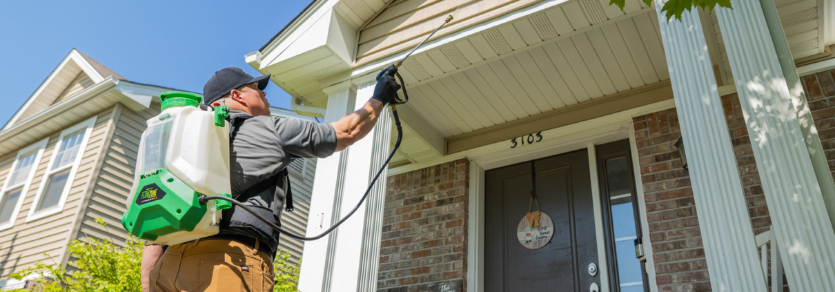 Amco Ranger exterminator conducting a thorough pest inspection in a residential home.