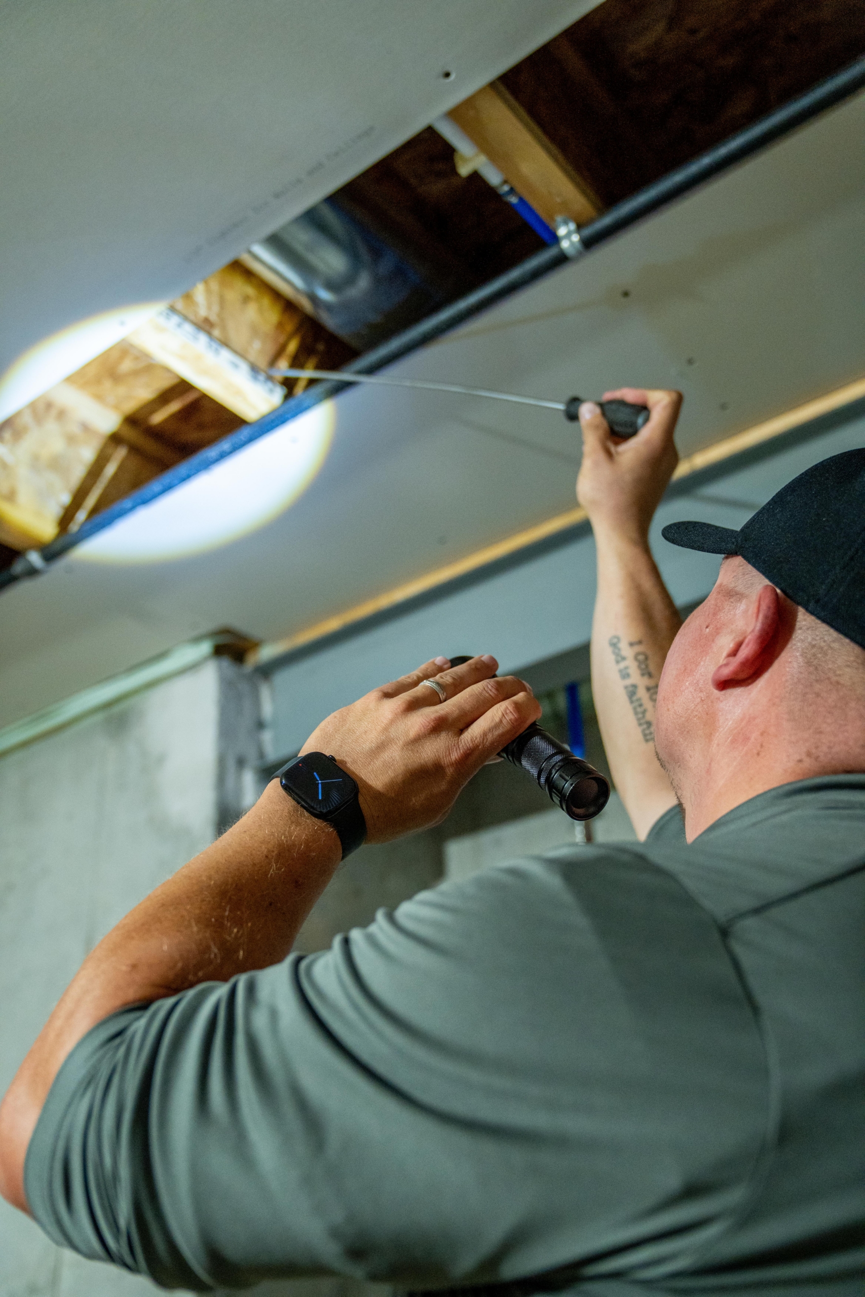 Annual Termite Inspections in St. Louis: Why Early Detection Saves You Thousands 2 Professional termite inspection: An Amco Ranger technician in St. Louis uses a flashlight and probe tool to check wooden joists for hollow spots and structural termite damage in a building ceiling