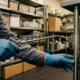 Commercial pest control technician treating a restaurant kitchen for pests in St. Louis.