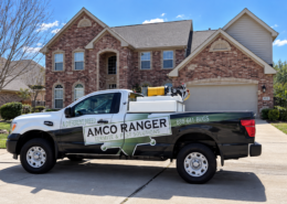 Amco Ranger lawn pest control truck equipped with spray tank treatment equipment parked outside a Missouri home