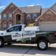 Amco Ranger lawn pest control truck equipped with spray tank treatment equipment parked outside a Missouri home